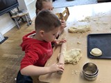 Children at table rolling pastry